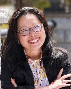 a woman with black hair smiling on the TCC Bridge